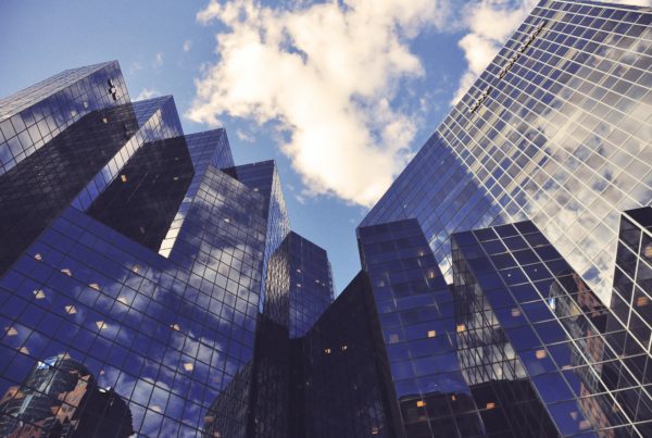 Glass buildings reflecting the sky